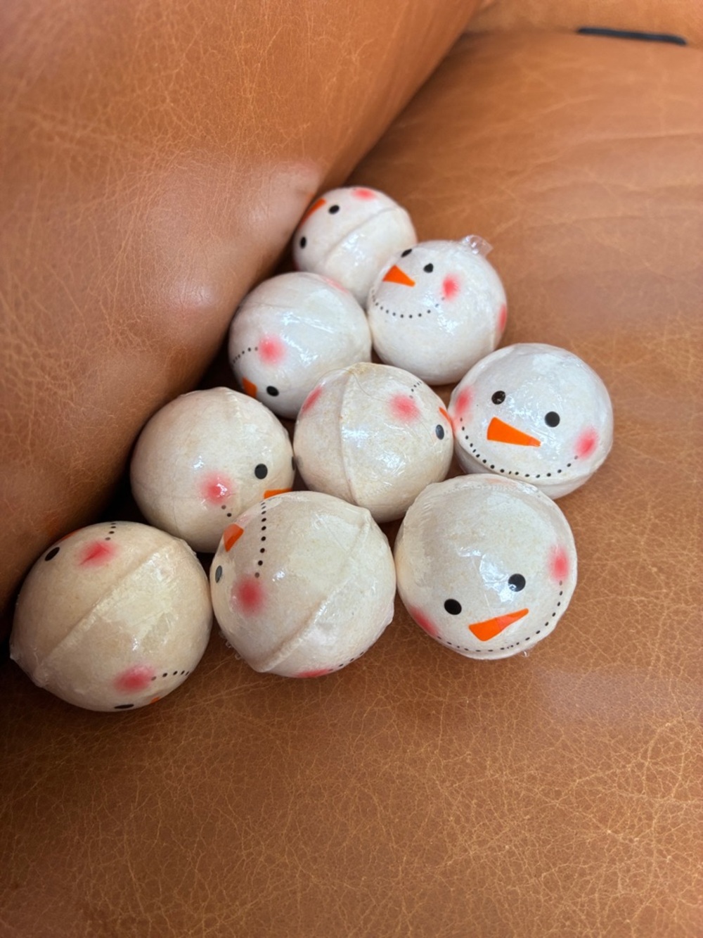 Set of 9 Snowman Bath Bombs - Cream with Orange & Pink Accents.